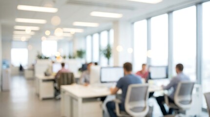 a blurred view of a modern open plan office space with several people working at their computers showing a collaborative environment high quality