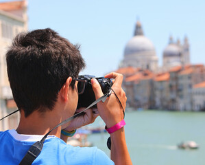 young photographer venice italy and monument in background