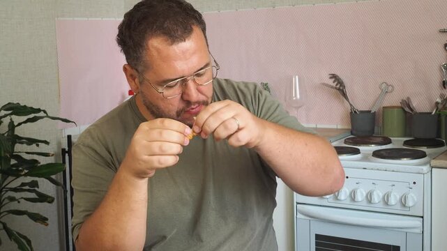 A man eats a cheburek fried in oil.