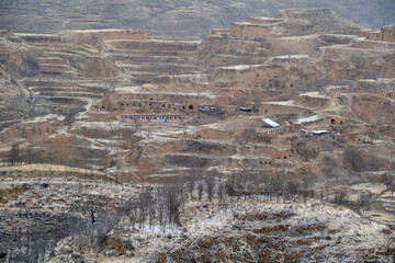 Panoramic view of traditional settlement nestled in loess plateau mountain valleys