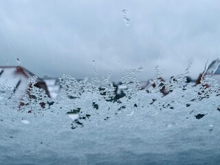 melting snow on a skylight, photographed from inside