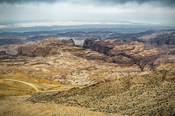 Landscape with cracked desert Wadi Rum under cloudy sky