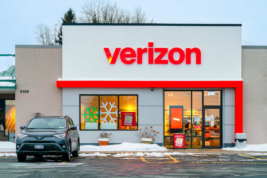 New Hartford, NY - Dec 28, 2025: Verizon, a U.S. telecom company founded in 2000, shown with holiday signage and snow-covered storefront at retail location