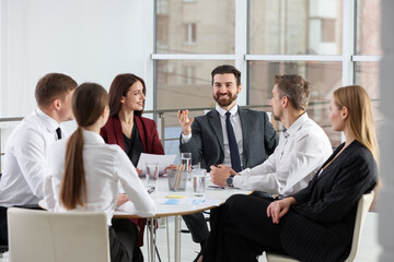 Businesspeople working together at table in office