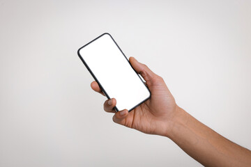 Man holding smartphone with blank screen on light background, closeup. Mockup for design