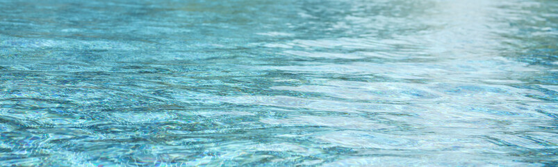 Swimming pool with blue crystal clear water surface and ripple wave background