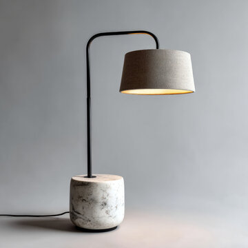 Elegant modern lamp with marble base on gray background.