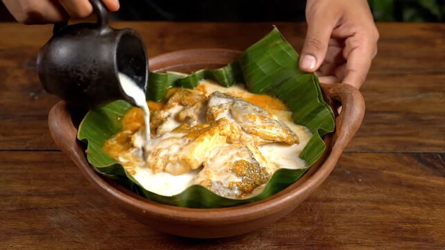 Gulai Ikan in Earthenware Bowl with Banana Leaf on Wooden Table Food Photography