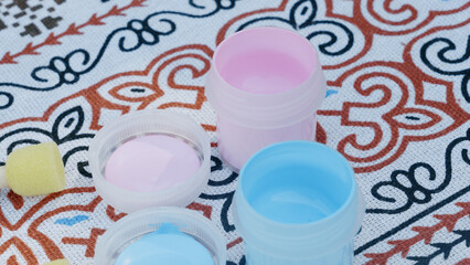 Pink and blue paint used for a gender reveal celebration, creating a playful and vibrant atmosphere.