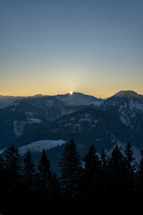 sunrise in the mountains in winter above the summits of Bregenzerwald in Vorarlberg Austria on a clear frosty morning 