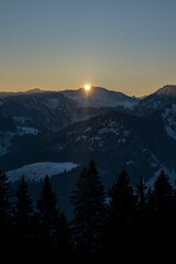 sunrise in the mountains in winter above the summits of Bregenzerwald in Vorarlberg Austria on a clear frosty morning 