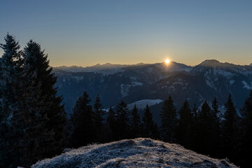 sunrise in the mountains in winter above the summits of Bregenzerwald in Vorarlberg Austria on a clear frosty morning 