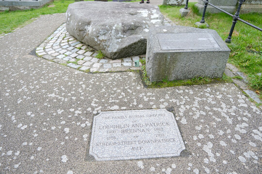 Granite memorial stone and informational plaque at the Grave of Saint Patrick in Downpatrick, Northern Ireland