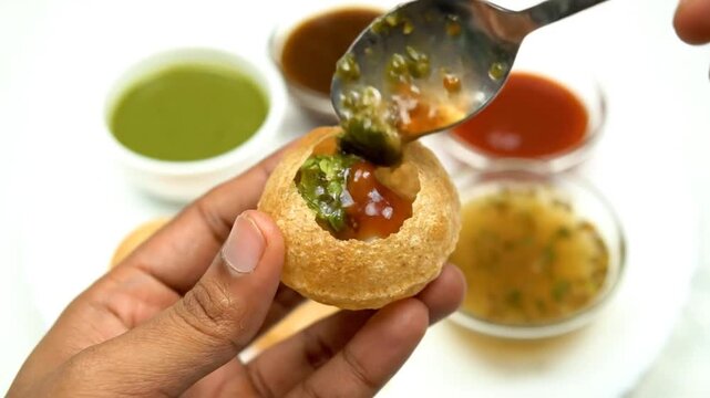 Preparing Pani Puri Round Crispy Shells Filling with Potatoes and Green Sauce a Popular Indian Street Food Snack on