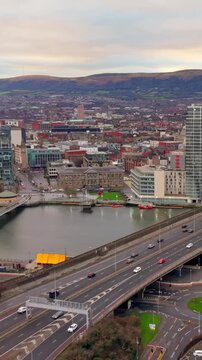 Travelling vertical social ratio aerial video of Belfast City Centre traffic and the River Lagan on a bright day. Produced in 1080x1920 and with Rec709 color.