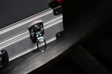 Close up of a silver metal briefcase latch