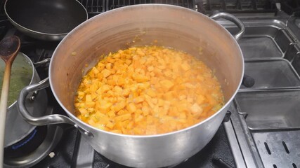 Preparing foundational flavor for a regional soup by sautéing aromatics and hand-cut sweet potatoes, ith a sautéed soffritto of onions and carrots, followed by uniform concassé of Ipomoea batatas.