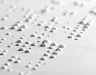 A close-up view of textured Braille dots on white paper, offering a tactile reading experience for the visually impaired and representing accessible communication