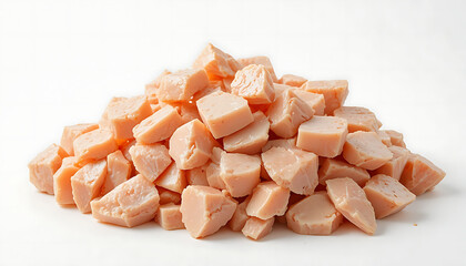 A pile of cut up uncooked boned chicken breast isolated on white.
