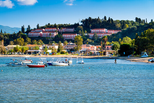 View Sidari Beach with tourists and boats on green holiday island Corfu, Greece. One the most beautiful islands in Ionian Sea.
