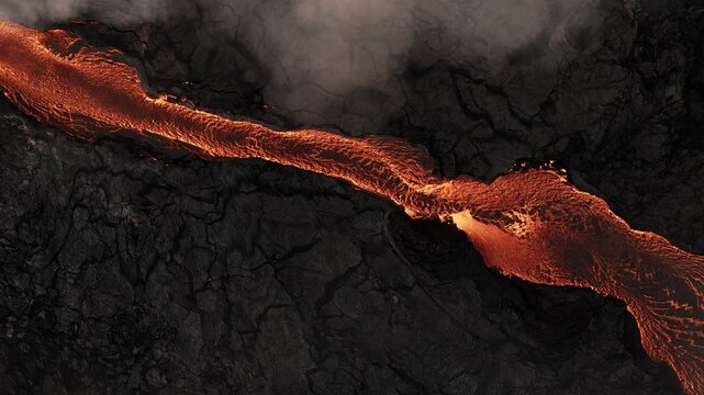 Aerial top-down shot of a molten lava river cutting through a desolate, blackened volcanic landscape. Fractured textures of the hardened basalt creates a powerful sense of geological energy.
