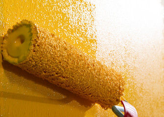 Painting a house wall with roller