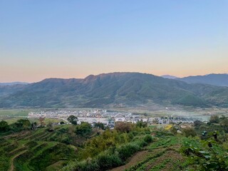 Fototapeta premium view from the top of the mountain - Terrace Farming, Cultivation farming, Terraced Rice Farming, or Bench Terraces - Asia agriculture, an ancient villages at Wuyuan, China