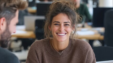 Entrepreneur and colleague talk during meeting in office while sharing ideas and engaging in discussion about business strategy