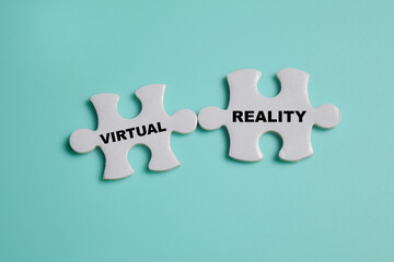 Piece of jigsaw puzzle with word virtual and reality. Business and finance concept