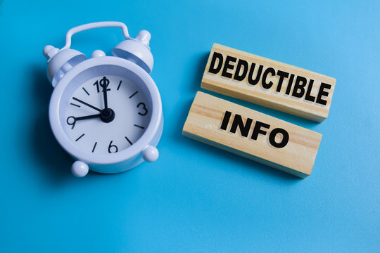 Concept of text deductible info on wooden blocks.