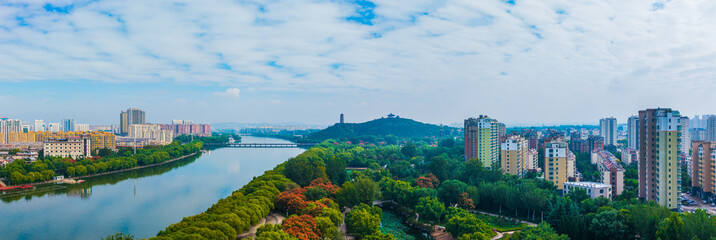 China Linqu ancient tower and urban garden architecture river landscape © guoquan
