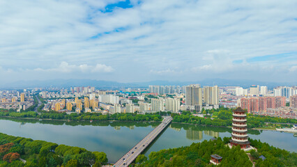 China Linqu ancient tower and urban garden architecture river landscape © guoquan