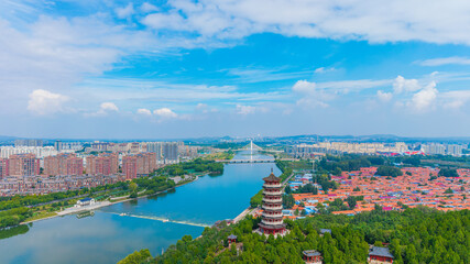 China Linqu ancient tower and urban garden architecture river landscape © guoquan