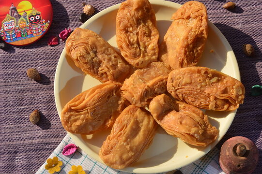 Khaja a deep- fried pastry that is often soaked in sugar syrup or filled with fruits. It is a popular sweet in Odisha India.