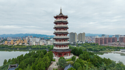 China Linqu ancient tower and urban garden architecture river landscape © guoquan