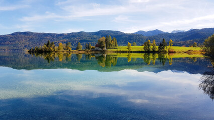 Obraz premium Walchensee, often called the “Caribbean of Bavaria,” known for its striking turquoise water and dramatic alpine setting. Surrounded by steep mountain slopes and open alpine meadows
