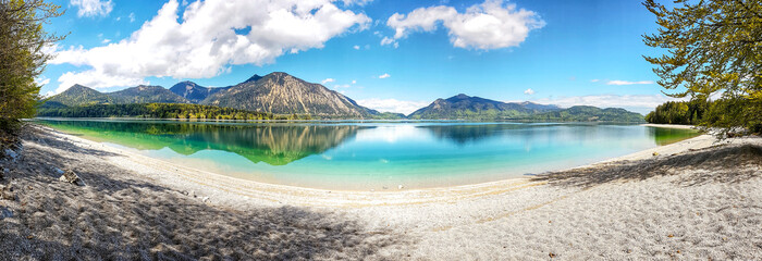 Walchensee, often called the &ldquo;Caribbean of Bavaria,&rdquo; known for its striking turquoise water and dramatic alpine setting. Surrounded by steep mountain slopes and open alpine meadows