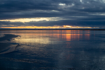 winter sunset above the frozen sea in Nallikari Oulu, Finland