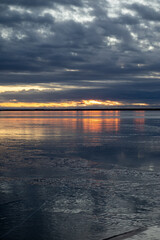 winter sunset above the frozen sea in Nallikari Oulu, Finland