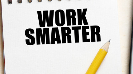 WORK SMARTER words written in an office notebook.