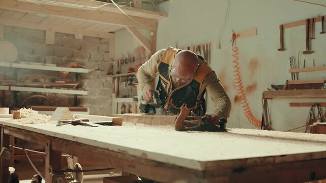 Wood, sander and carpenter in workshop with tools for furniture, production or construction project.