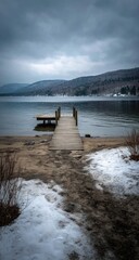 Calm winter lake scene with a wooden dock