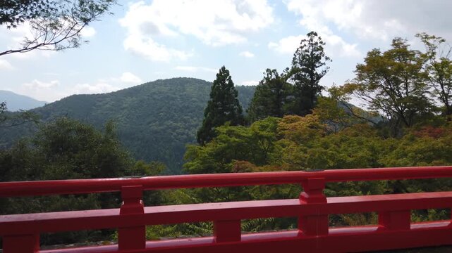 Panning at Kuramadera Temple of Kyoto Japan with mountain forest landscape and orange railing, viewpoint