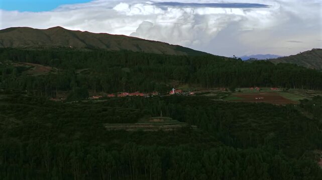 Cristo Blanco Jesus statue Cusco vive en Peru Per&uacute; aerial drone Cuzco Red Hill Saqsaywaman cityscape Peruvian Andes landscape landmark rainy season dark clouds sunset Inca Empire capitol circle right