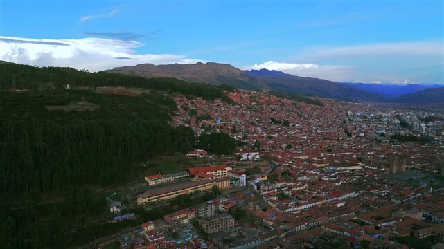Cristo Blanco Jesus statue Cusco vive en Peru Per&uacute; aerial drone Cuzco Red Hill Saqsaywaman cityscape red buildings Peruvian Andes landscape rainy season sunset Inca Empire capitol circle right motion