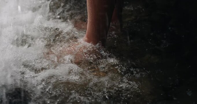 Slow motion static captures bare feet standing firm amid surging white foam of &Ouml;tschergr&auml;ben waterfall, embodying ritual immersion in primal &Ouml;tscherbach flow near Mirafall, Austria.