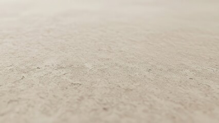 Subtly textured light beige concrete or natural stone background surface with a rustic, organic finish, captured with a shallow depth of field extending into a soft-focus blur, presenting a minimalist