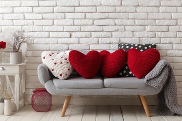 This inviting and cozy interior scene features a stylish modern grey sofa adorned with a charming collection of heart-shaped pillows, creating a warm and affectionate atmosphere. Three vibrant red kni