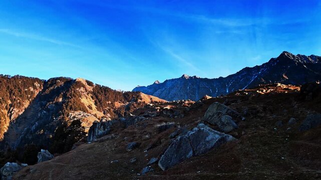 Aerial drone shot of Triund hilltop overlooking the Dhauladhar mountain range. Popular trekking spot in Himachal Pradesh