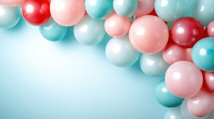 A vibrant collection of pastel balloons in pink, red, and aqua colors elegantly arranged against a softly illuminated background, perfect for party and celebration themes.